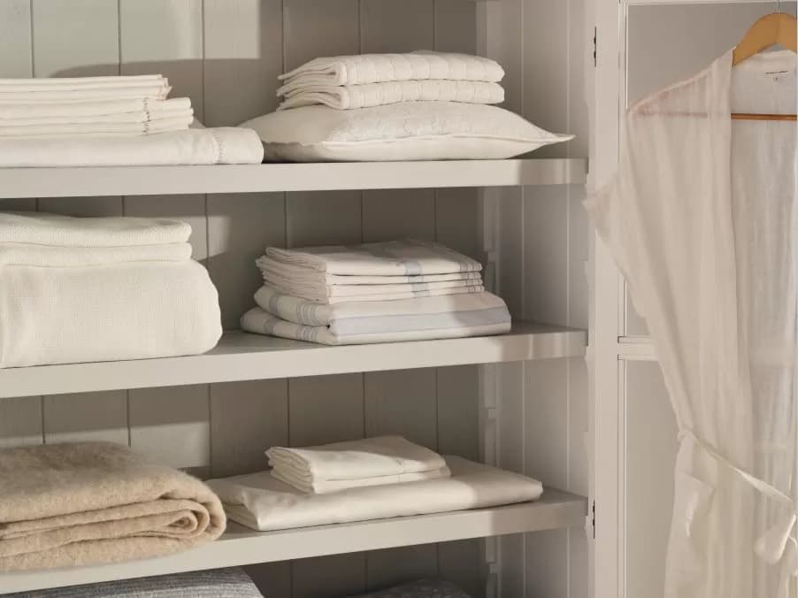 Shelves filled with folded bed linen